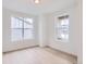 Cozy bedroom with hardwood floors, two large windows for ample sunlight, and neutral decor at 5601 Inland Ave, Firestone, CO 80504