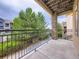 Balcony with iron railing and views of the trees and grounds at 3155 E 104Th Ave # 4E, Thornton, CO 80233