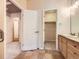 Bathroom with tile flooring, a vanity with storage, and a view into the walk-in closet at 3155 E 104Th Ave # 4E, Thornton, CO 80233