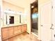 Bright bathroom featuring a double sink vanity, tiled floors, and a glass-enclosed shower for a luxurious feel at 3155 E 104Th Ave # 4E, Thornton, CO 80233