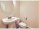 Powder room with pedestal sink, toilet, and neutral color scheme at 3155 E 104Th Ave # 4E, Thornton, CO 80233