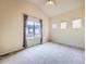 Bedroom with large window allowing ample natural light, ceiling fan, and neutral carpeting at 3155 E 104Th Ave # 4E, Thornton, CO 80233