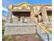 Detailed exterior showcases stone accents, private balconies, and inviting entrance stairs at 3155 E 104Th Ave # 4E, Thornton, CO 80233