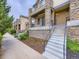 Stunning multi-level townhouse with stone accents, inviting balconies, and professionally landscaped grounds at 3155 E 104Th Ave # 4E, Thornton, CO 80233