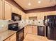Bright kitchen featuring granite countertops, black appliances, and tile backsplash at 3155 E 104Th Ave # 4E, Thornton, CO 80233
