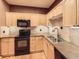 Well-equipped kitchen with granite countertops, black appliances, and ample cabinet space at 3155 E 104Th Ave # 4E, Thornton, CO 80233