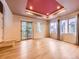 Bright living room with hardwood floors, large windows, and a unique coffered ceiling design at 3155 E 104Th Ave # 4E, Thornton, CO 80233