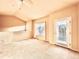 Spacious living room featuring neutral carpet, natural light, and a ceiling fan at 3155 E 104Th Ave # 4E, Thornton, CO 80233