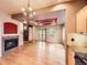 Open living room and kitchen area with hardwood floors, fireplace, and stylish chandelier at 3155 E 104Th Ave # 4E, Thornton, CO 80233