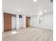 Finished basement with light walls, wood flooring, and large closets at 725 S Harrison St, Denver, CO 80209