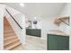 Finished basement with wood stairs, green cabinets, and vinyl flooring at 725 S Harrison St, Denver, CO 80209