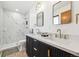 Modern bathroom with marble shower, double vanity, and gold fixtures at 725 S Harrison St, Denver, CO 80209