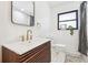 Updated bathroom features a modern vanity, gold fixtures, and a marble shower at 725 S Harrison St, Denver, CO 80209