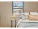 Bedroom detail with wood-paneled accent wall and window at 725 S Harrison St, Denver, CO 80209