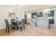 Modern dining area with a round table and chairs, adjacent to the kitchen at 725 S Harrison St, Denver, CO 80209