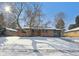 Brick ranch home with a spacious yard, partially covered in snow at 725 S Harrison St, Denver, CO 80209