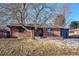 Brick ranch house with a mature tree and well-maintained landscaping at 725 S Harrison St, Denver, CO 80209