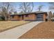 Attractive single story brick home features a lengthy driveway, and attached garage at 725 S Harrison St, Denver, CO 80209