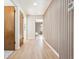 Light-filled hallway with wood floors and modern wood wall accents at 725 S Harrison St, Denver, CO 80209