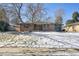 Brick ranch house with a snow-covered lawn at 725 S Harrison St, Denver, CO 80209