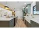 Modern kitchen with dark green cabinets, white countertops, and stainless steel appliances at 725 S Harrison St, Denver, CO 80209