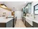 Modern kitchen with green cabinets, white countertops, and island at 725 S Harrison St, Denver, CO 80209