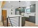 Modern kitchen with green cabinets, quartz countertops, and island at 725 S Harrison St, Denver, CO 80209