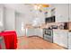 Bright kitchen features white cabinetry, stainless steel appliances, and natural wood floor at 1315 Xanthia St, Denver, CO 80220