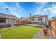 Spacious backyard featuring artificial turf, brick patio, and perimeter fence at 1578 N Meade N St, Denver, CO 80204