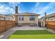 This beautiful backyard features a manicured lawn, brick patio, privacy fence, and access to updated mechanicals at 1578 N Meade N St, Denver, CO 80204