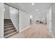 Finished basement with open layout, hardwood floors, and staircase at 1578 N Meade N St, Denver, CO 80204
