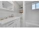 Bathroom featuring a tiled shower, single sink vanity, and shelving at 1578 N Meade N St, Denver, CO 80204