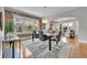 Open dining area with exposed brick wall and seamless flow to the living room at 1578 N Meade N St, Denver, CO 80204
