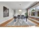 Bright dining room with exposed brick wall and modern light fixture at 1578 N Meade N St, Denver, CO 80204