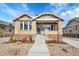 Charming brick home with well-maintained landscaping and inviting front porch at 1578 N Meade N St, Denver, CO 80204