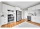Modern kitchen featuring white cabinetry, stainless steel appliances, and hardwood floors at 1578 N Meade N St, Denver, CO 80204