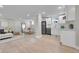 Open-concept living area with kitchenette, modern decor, and plenty of natural light at 1578 N Meade N St, Denver, CO 80204