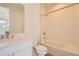 Modern bathroom with sleek white vanity, toilet, and tiled shower-over-tub perfect for relaxation at 641 Skyhook St, Erie, CO 80516
