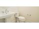 Cozy half-bathroom featuring a pedestal sink and matching white toilet at 641 Skyhook St, Erie, CO 80516