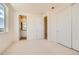 Bright bedroom featuring a private bathroom and a spacious closet perfect for modern living at 641 Skyhook St, Erie, CO 80516