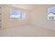 Bright bedroom with large windows providing natural light and neutral carpet at 641 Skyhook St, Erie, CO 80516
