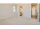 A clean, carpeted bedroom with ample natural light and views of the neighborhood at 641 Skyhook St, Erie, CO 80516