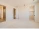 Spacious bedroom with ensuite bathroom and walk-in closet featuring neutral paint and plush carpet at 641 Skyhook St, Erie, CO 80516