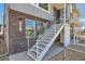 Exterior view of stairway that leads to the second floor entrance of this townhome, with nice window details at 641 Skyhook St, Erie, CO 80516