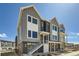 Charming two-story townhome featuring modern architecture and inviting entry with stairway to a second floor unit at 641 Skyhook St, Erie, CO 80516