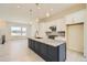 Spacious kitchen with a large central island, stainless steel appliances and modern pendant lighting at 641 Skyhook St, Erie, CO 80516