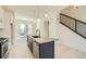 Bright kitchen features a large island with stainless steel appliances and modern pendant lighting at 641 Skyhook St, Erie, CO 80516