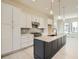 Well-appointed kitchen with white cabinets, stainless steel appliances, an island, and modern pendant lighting at 641 Skyhook St, Erie, CO 80516
