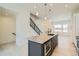 This kitchen features a large center island with a stone countertop and modern stainless appliances at 641 Skyhook St, Erie, CO 80516