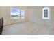 Spacious and bright living room with large windows offering plenty of natural light, and light wood floors at 641 Skyhook St, Erie, CO 80516